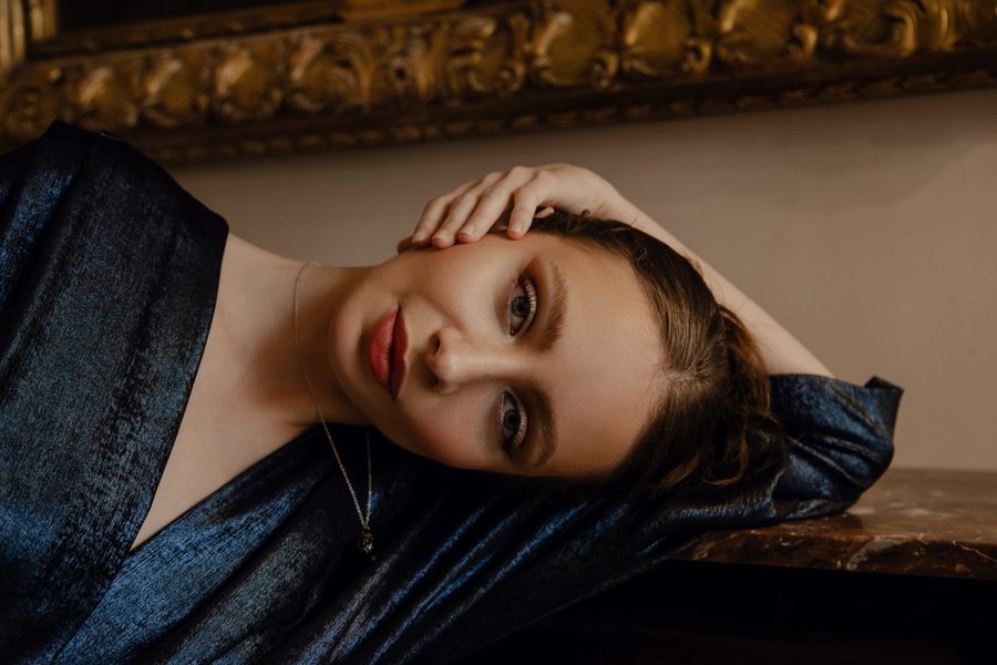 Modern editorial portrait with clean lines and soft colour palette